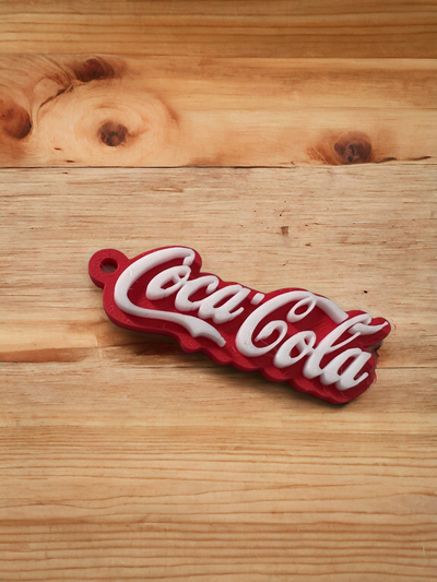 coca coca cola logo portachiavi ams necessario by lilla rabbia arte segni loghi cola chiave catena squillare 3d print model - Mito3D