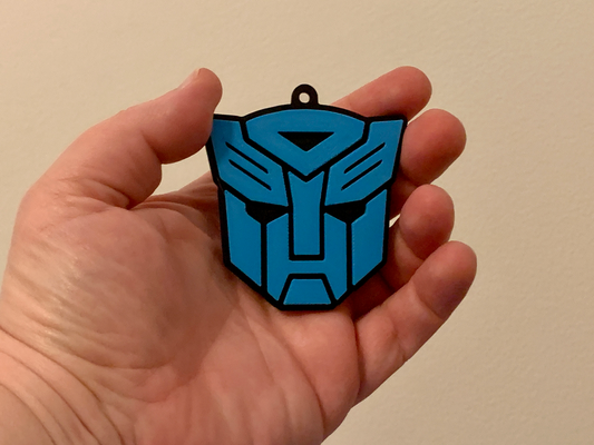 transformers autobots keychain - two color filament swap at layer height no ams needed by lilac rage art signs & logos decepticons autobot optimus prime transformer logo 80s tv key chain keyring ring robot robots 3d print model - Mito3D
