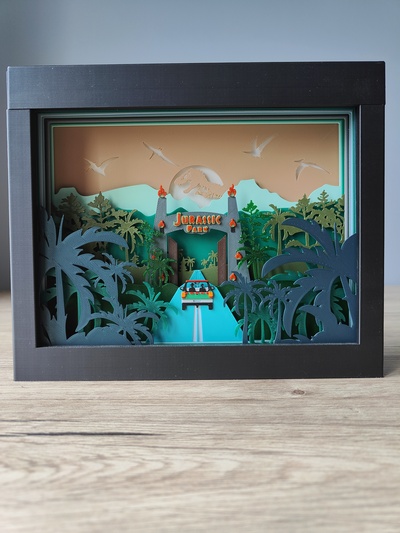jurassique parc ombre boîte by rusé fabricant art panneaux logos dinosaure film shadowbox 3d print model - Mito3D