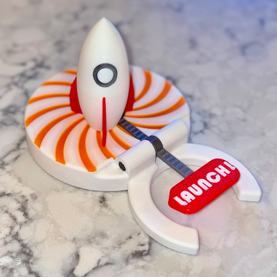 rocket pop desk toy by vega3dprinting household decor flying machine contest lever accessory launcher pad launch shoot fly 3d print model - Mito3D
