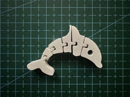 flexi dolphin remixed by t stk art signs & logos toy desk segments 3dprinting printinplace body flex nosupport segment doplhin 3d print model - Mito3D