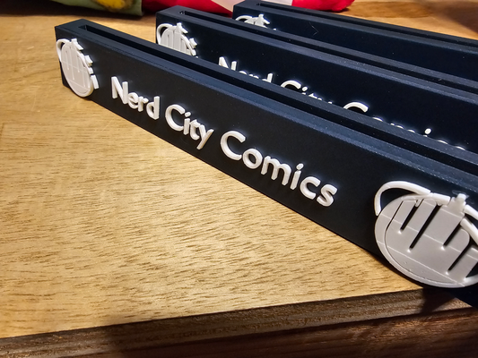 comic book stand plate - nerd city comics by gregorydonnell74 hobby & diy books 3d print model - Mito3D